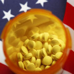 Open Pill Bottle On American Flag