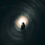 woman-praying-in-a-dark-place-picture-id543574284