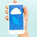 Conceptual phone showing a cloud and bird on blue background