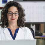 Health professional entering data into computer