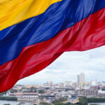 Colombian flag waving on the wind and modern Cartagena district