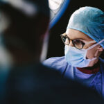 Female surgeon with team performing surgery