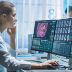 Female Medical Research Scientist Working with Brain Scans on He