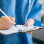 Doctor signing papers