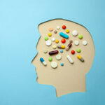 The profile of man and in his head lot of pills. Headache treatm